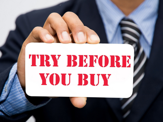 Man in suit holding the Machismo Plus Try Before you Buy Sign