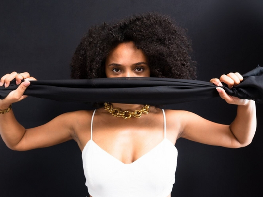 Photo of a coloured woman with a black cloth over her face
